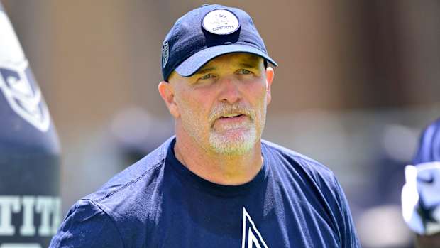 Dallas Cowboys offensive coordinator Dan Quinn watches over training camp drills.
